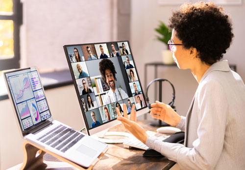 person gesturing at screen full of faces
